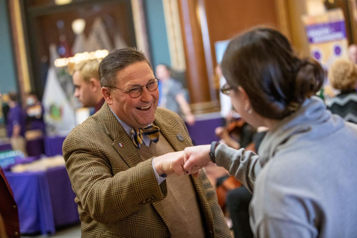 UNI Day at the Capitol: Representative Jon Dunwell does a fistbump with a UNI staff person